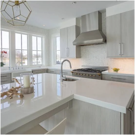 Bright modular kitchen with polished white island countertop and sink